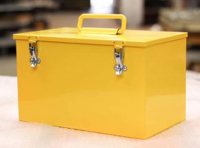 Large yellow box with handle and latches.